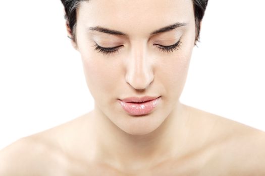 beautiful girl with short black hair, looking down, against white background