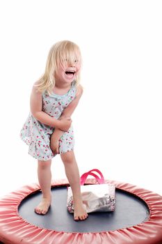 cute little girl having fun on a trampoline