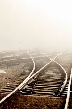 Railway in fog on station, outdoor landscape