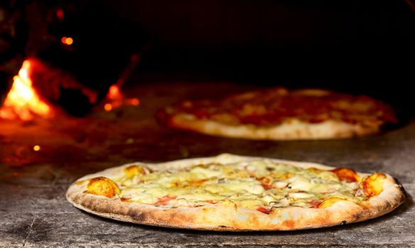 delicious pizza baking in wood fired oven