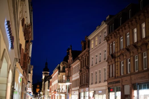 Heidelberg, Germany - February 2, 2013: Tourists walking through the centre of Heidelberg, Germany with its beautiful medieval houses in the evening of February 2, 2013. Heidelberg is a well-known tourist attraction due to its old history and beautiful location at the Neckar river.