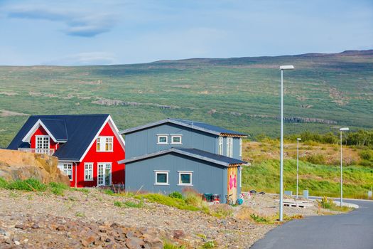 Beautiful house in Iceland. Mountains in background.