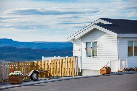 Beautiful house in Iceland. Mountains in background.