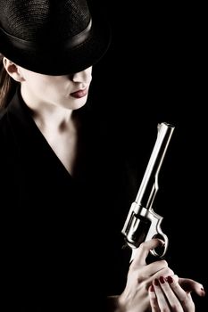 elegant lady in black holding a revolver