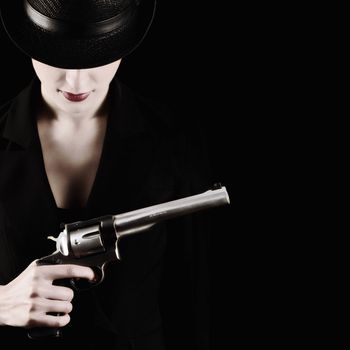 elegant lady in black holding a revolver