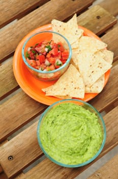 Guacamole dip made from fresh avocadoes, chips and salsa