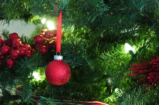 close up of ornaments on a decorated christmas tree for the holidays