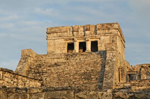 Ancient Mayan Temple Ruins agains blue and cloudy sky in Mexico