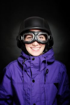 girl with us-army style helmet and goggles, on black