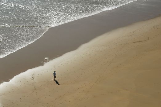 man jogging on the beach lonely