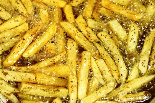 french fries - baking potatoes in hot oil