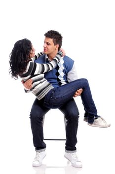 portrait of a young couple sitting on a chair isolated on white