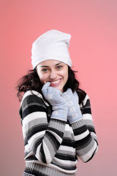 portrait of a beautiful young girl smiling, on pink background