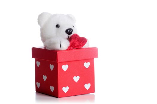 teddy bear with a heart on a red gift box