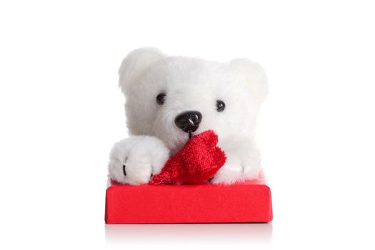 teddy bear with a heart on a red gift box