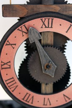 Imitation antique wall clock with arrows and numbers.