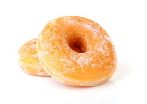Two delicious sugared donuts over white background