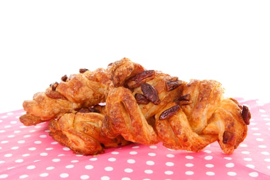 Three delicious luxury buns on napkin over white background