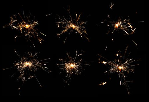 many burning spakrlers isolated on black background