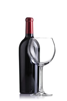 isolated red wine bottle and an empty glass, focus on glass