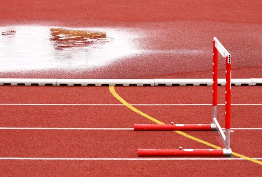 Hurdle on the runway on a rainy day