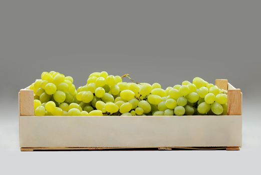 fresh green grapes in a wooden crate