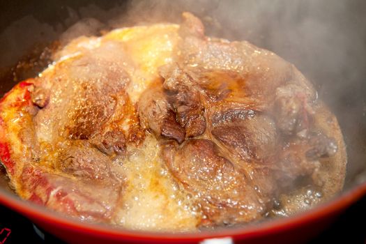 Closeup of baking beef in saucepan