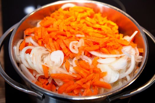 Closeup of Carrots and onions for Dutch hutspot stew in pan