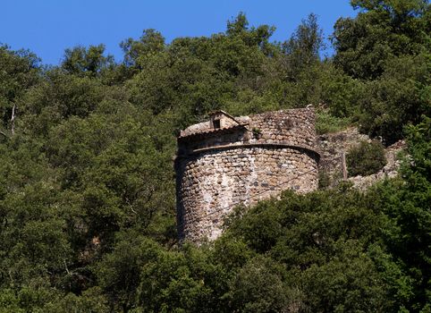Castle tower surrounded by trees in Ardèche, France