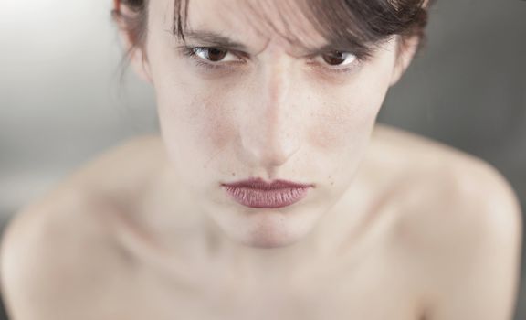Close up studio portrait of an angry girl