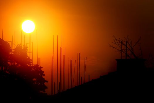 construction site sunset, silhouettes of an urban area