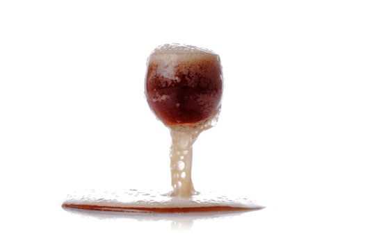 overflowing soda in a glass, isolated on white
