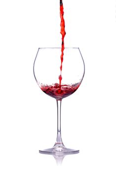 red wine splashing in a glass, isolated on white