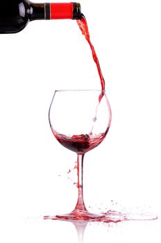 red whine pouring in a glass, isolated on white