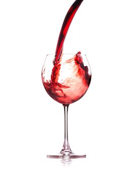 red wine splashing in a glass, isolated on white