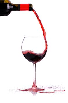 red whine pouring in a glass, isolated on white