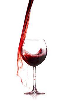 red wine splashing in a glass, isolated on white