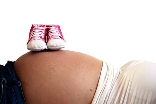 pregnant tummy with little pink shoes