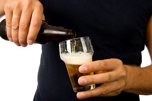 Man is pouring beer into glass isolated on white background