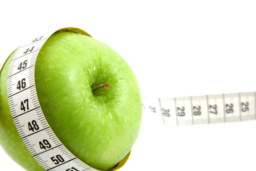 Fresh green apple with measure tape isolated on white background