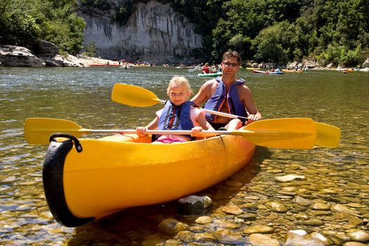 Father and daughter in canoe enjoying the holidays