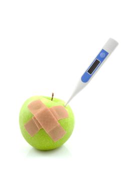 Sick green apple with thermometer and patches isolated on white background