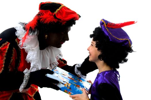 Zwarte piet ( black pete) typical Dutch character part of a traditional event celebrating the birthday of  Sinterklaas in december over white background with young child