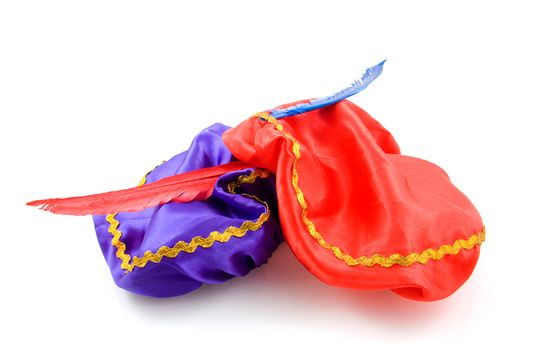purple and red hat with red feather of Zwarte Piet for typical Dutch event in december, isolated on white background