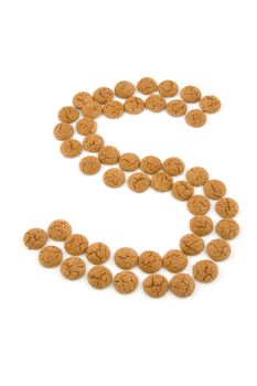 Ginger nuts, pepernoten, in the shape of letter S isolated on white background. Typical Dutch candy for Sinterklaas event in december.