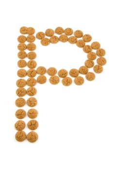 Ginger nuts, pepernoten, in the shape of letter P isolated on white background. Typical Dutch candy for Sinterklaas event in december.