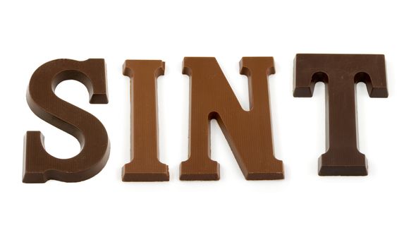 The word "Sint" in chocolate letters isolated on white background, typical Dutch candy for Sinterklaas event in december