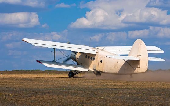 old airplane takes off on the field