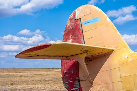 the tail part of the old plane the blue sky background