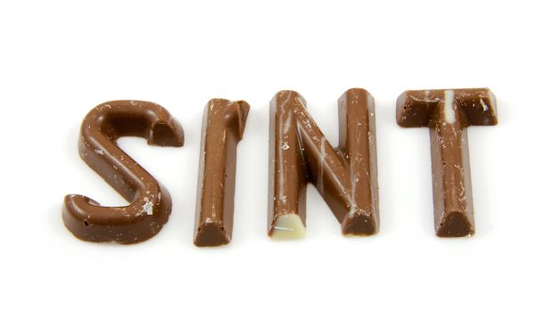 The word "Sint" in chocolate letters isolated on white background, typical Dutch candy for Sinterklaas event in december